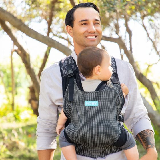 Image Moby Cloud baby carrier, black with white broken stripes. For babies 3.6 - 14.9kgs (8-33 lbs.), newborn to toddler. Light, airy design circulates airflow with Powermesh fabric. 2 ways to wear baby: inward-facing or forward-facing.